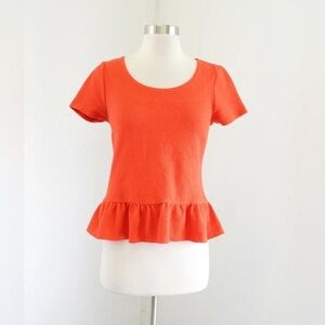 Anthropologie Postmark Cascata orange ruffled back peplum top